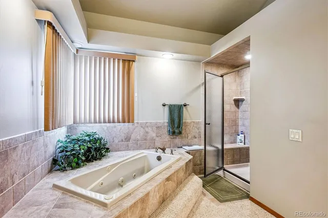 a bathroom with a tub and shower
