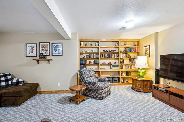 a living room with furniture gym equipment and a flat screen tv