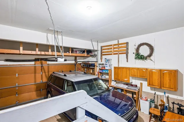 a room with furniture pool table and chairs