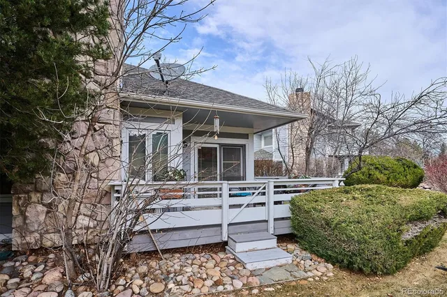 a view of a house with a chairs and table in a patio