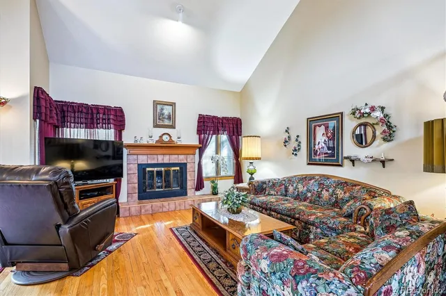 a living room with furniture a flat screen tv and a fireplace