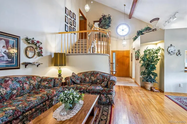 a living room with furniture and a clock