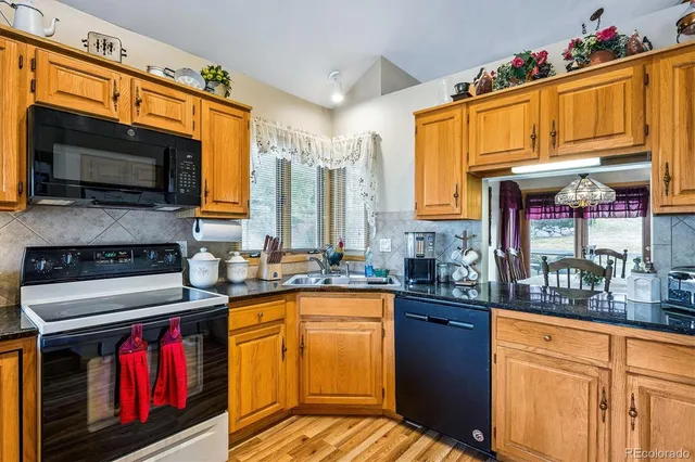 a kitchen with lots of counter top space and wooden floor