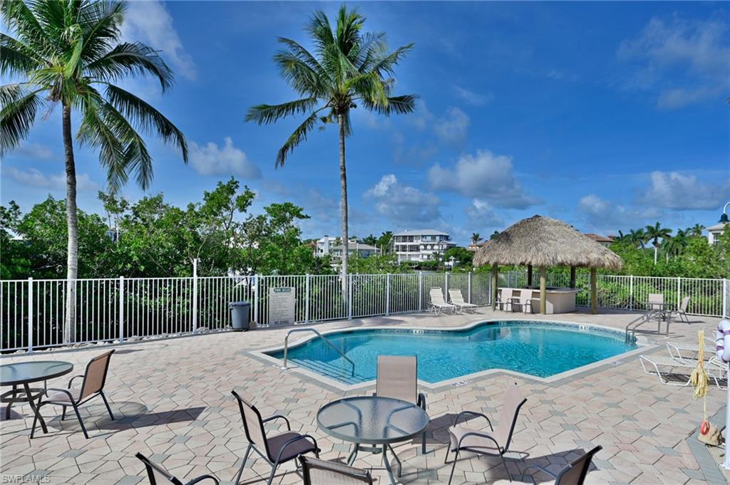 5025 Bonita Beach Road Southwest Bonita Springs, FL 34134 - Photo 6 of 23 a view of a lake with a table and chairs