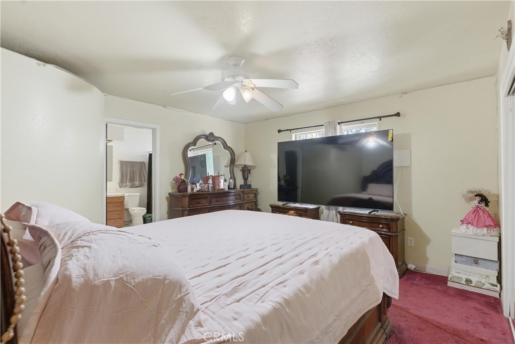 381 B Street Arvin, CA 93203 - Photo 11 of 23 a bedroom with a bed and a flat screen tv