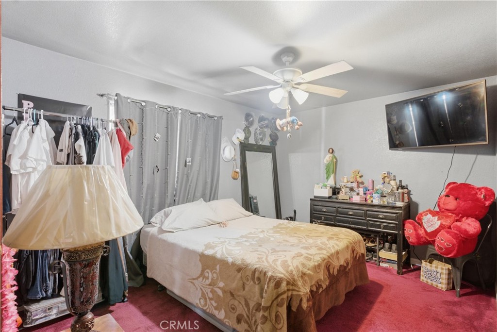 381 B Street Arvin, CA 93203 - Photo 14 of 23 a bed room with a bed and a flat screen tv