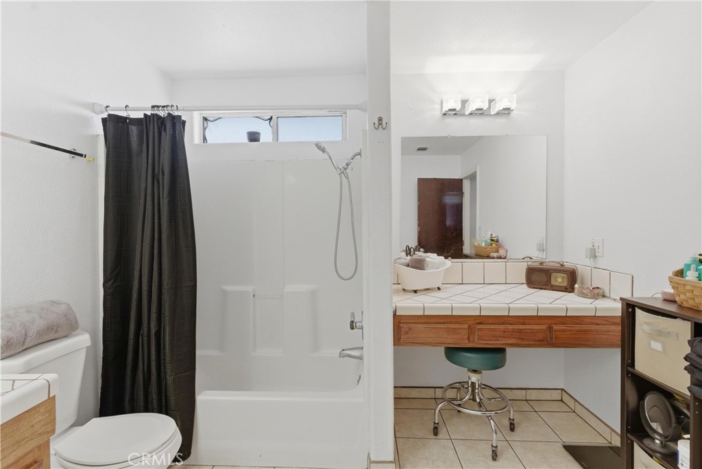 381 B Street Arvin, CA 93203 - Photo 17 of 23 a bathroom with a sink a toilet and a mirror
