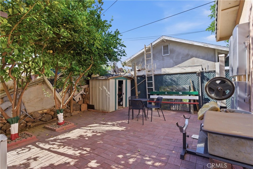 381 B Street Arvin, CA 93203 - Photo 19 of 23 a backyard of a house with barbeque oven table and chairs