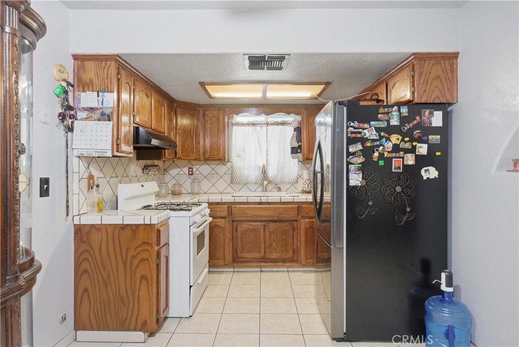 381 B Street Arvin, CA 93203 - Photo 8 of 23 a kitchen with stainless steel appliances granite countertop a refrigerator and a sink