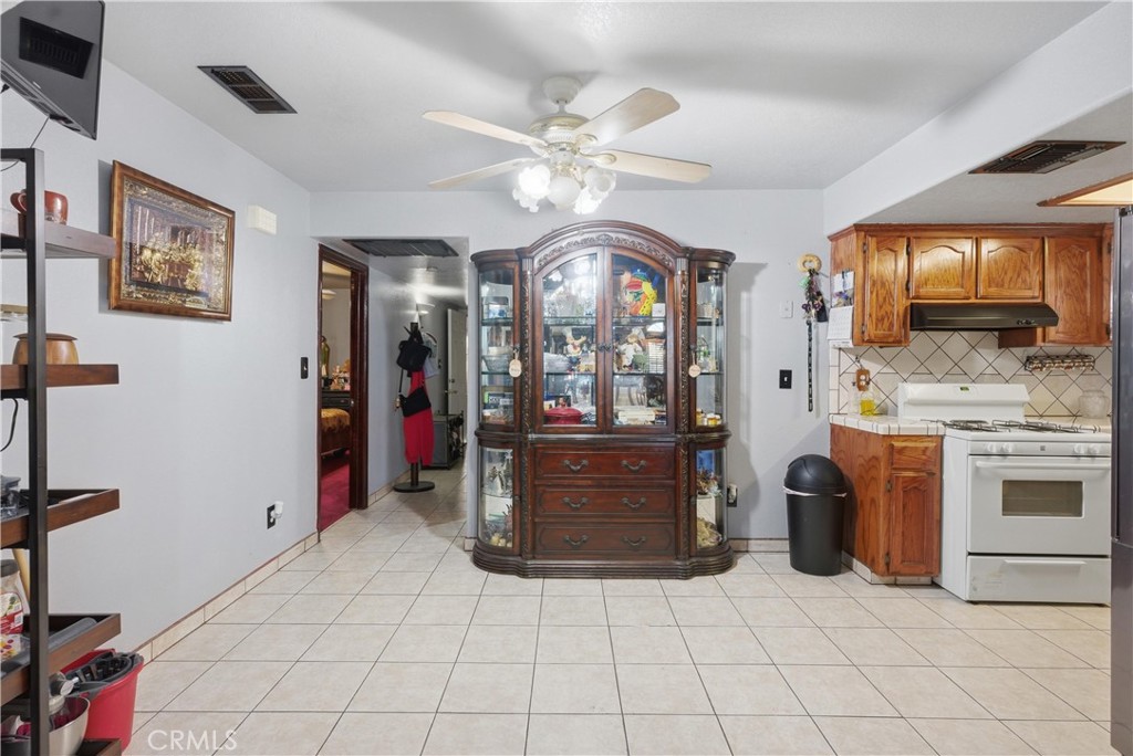 381 B Street Arvin, CA 93203 - Photo 9 of 23 a view of a kitchen with a sink and a refrigerator