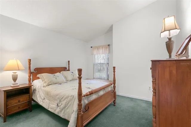 a bedroom with a bed and a lamp