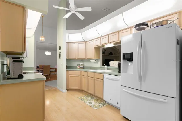 a kitchen with cabinets and refrigerator