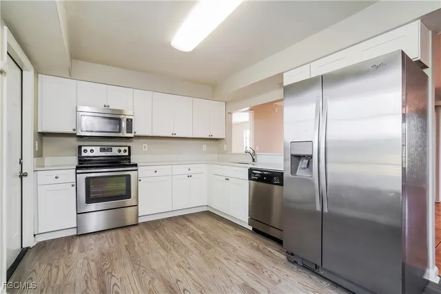 a kitchen with a refrigerator stove and microwave