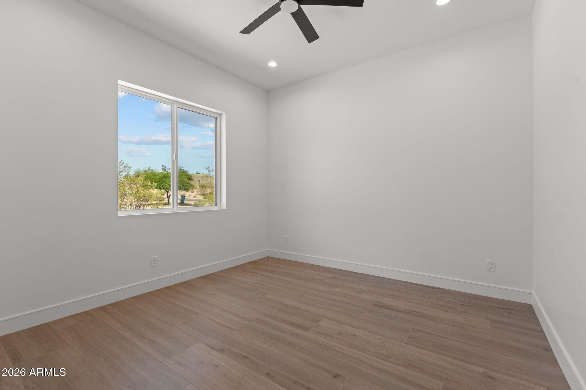 2855 Percheron Road Wickenburg, AZ 85390 - Photo 41 of 58 an empty room with wooden floor and ceiling fan