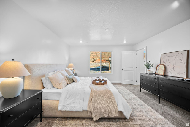 2123 Wolverine Way, Unit 2437 Washington, UT 84780 - Photo 37 of 40 Spacious bedroom with a large window, recessed lighting, and soft gray carpeting