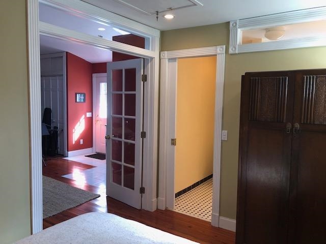 27 Williams Street, Unit GARAGE APARTMENT A St. Augustine, FL 32084 - Photo 10 of 11 a view of a hallway with wooden floor and dining room