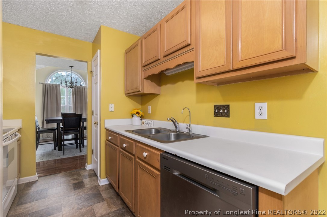1070 Roundabout Road Cameron, NC 28326 - Photo 14 of 34 a kitchen with a sink dishwasher and cabinets