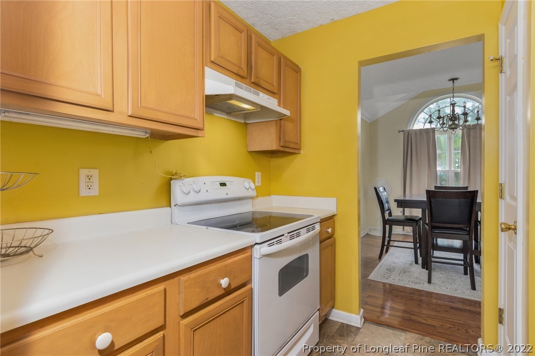 1070 Roundabout Road Cameron, NC 28326 - Photo 16 of 34 a kitchen with a stove and a table