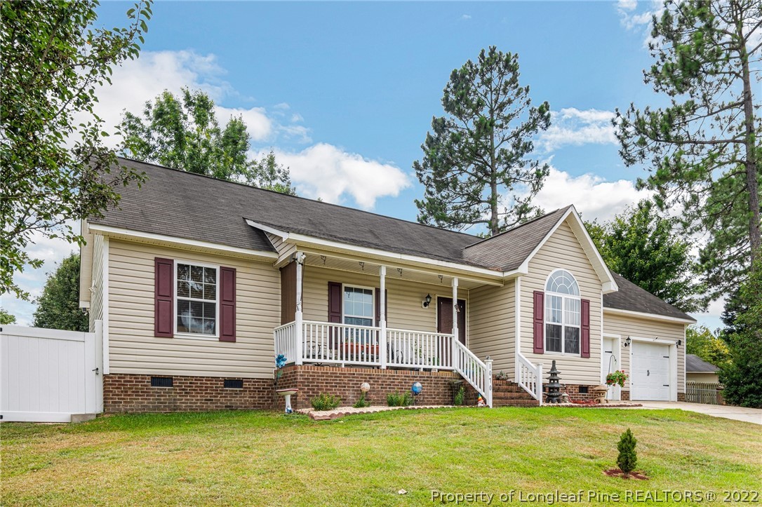 1070 Roundabout Road Cameron, NC 28326 - Photo 2 of 34 a front view of a house with a yard and trees