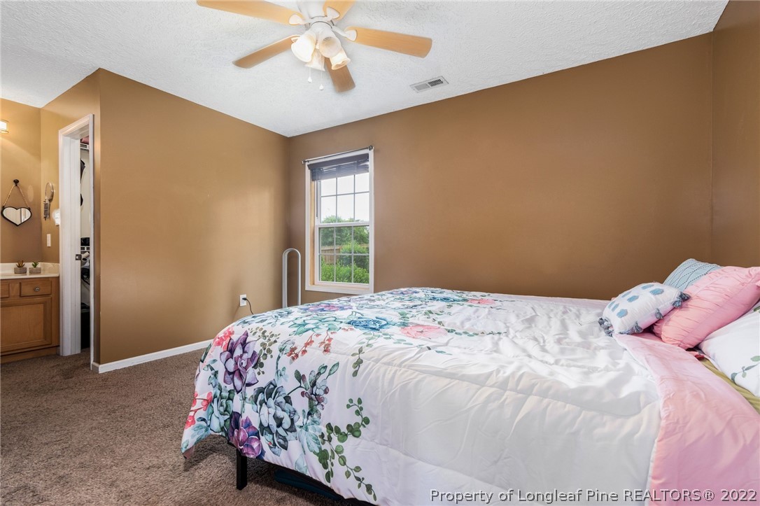 1070 Roundabout Road Cameron, NC 28326 - Photo 21 of 34 a bedroom with a bed and a window