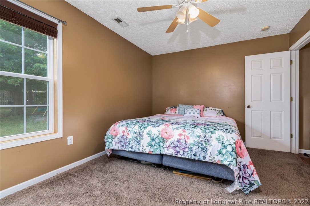 1070 Roundabout Road Cameron, NC 28326 - Photo 22 of 34 a bedroom with a bed and a window