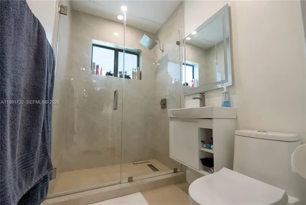a bathroom with a toilet sink and shower