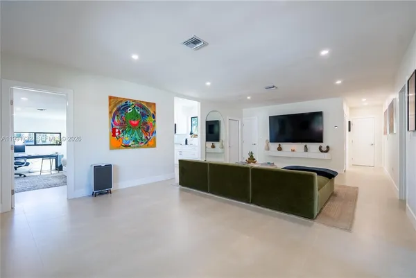 an empty room with furniture and flat screen tv