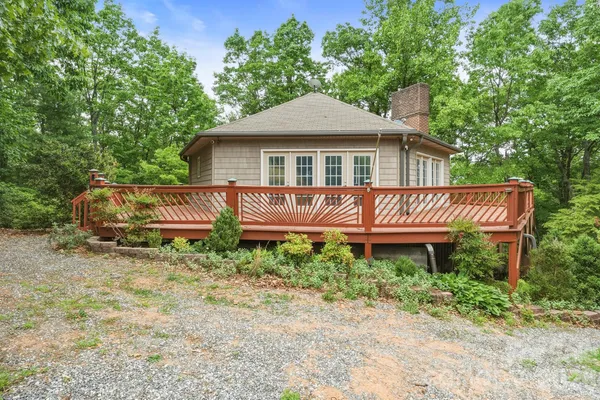 a view of a house with a wooden fence
