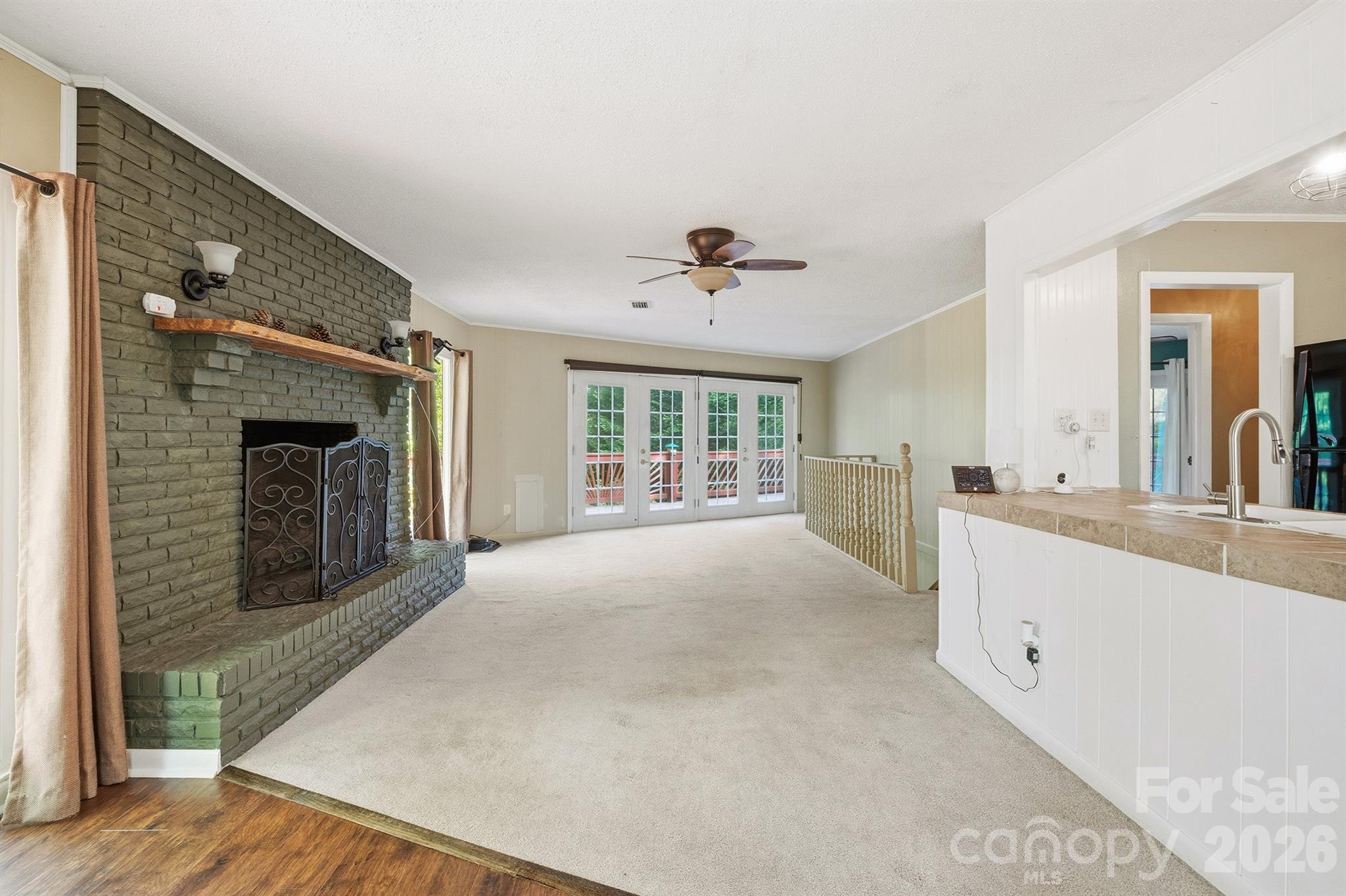 3190 Holly Road Connelly Springs, NC 28612 - Photo 30 of 42 a view of an empty room with a fireplace and a window