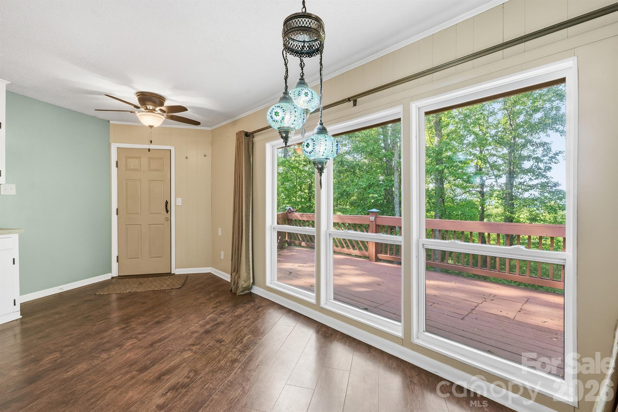 3190 Holly Road Connelly Springs, NC 28612 - Photo 31 of 42 a view of a room with wooden floor a ceiling fan and windows
