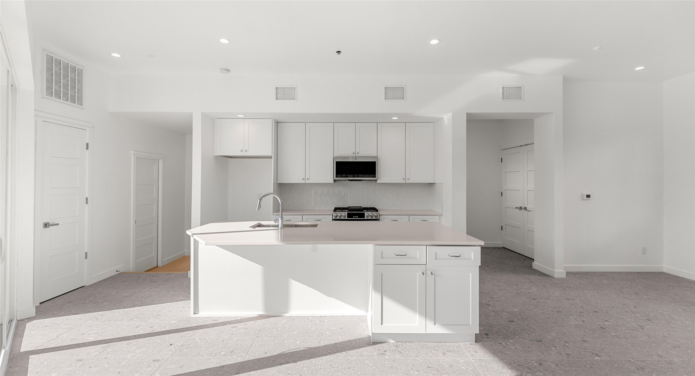 5912 Harold Court, Unit 106 Austin, TX 78721 - Photo 16 of 26 Bright, open interior space ready to flex around your life — a home office, a reading nook, or a quiet spot to unwind. Model No. 104 Shown.