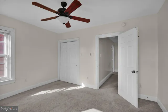 an empty room with windows and entrance