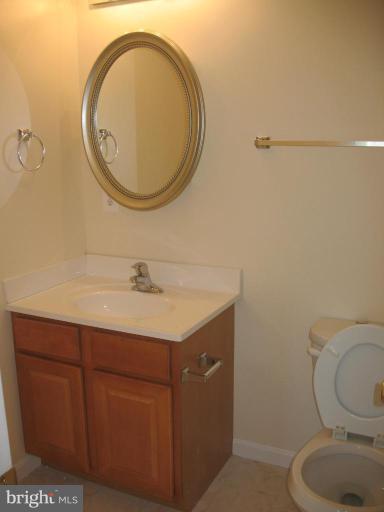 1848 Montreal Road Severn, MD 21144 - Photo 3 of 5 a bathroom with a granite countertop toilet sink and mirror