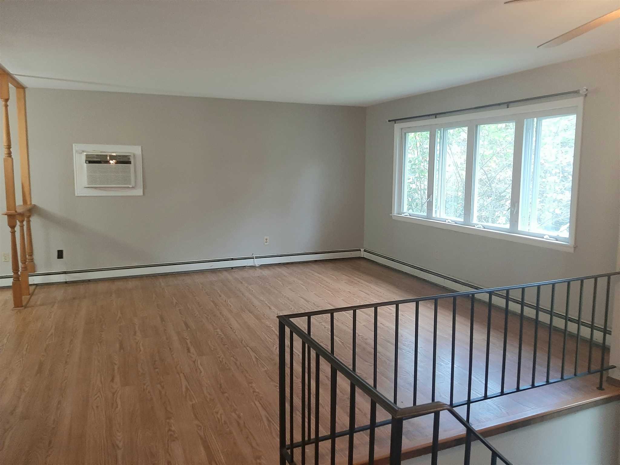 97 Sutton Park Road Poughkeepsie, NY 12603 - Photo 4 of 20 a view of an empty room with wooden floor and a window