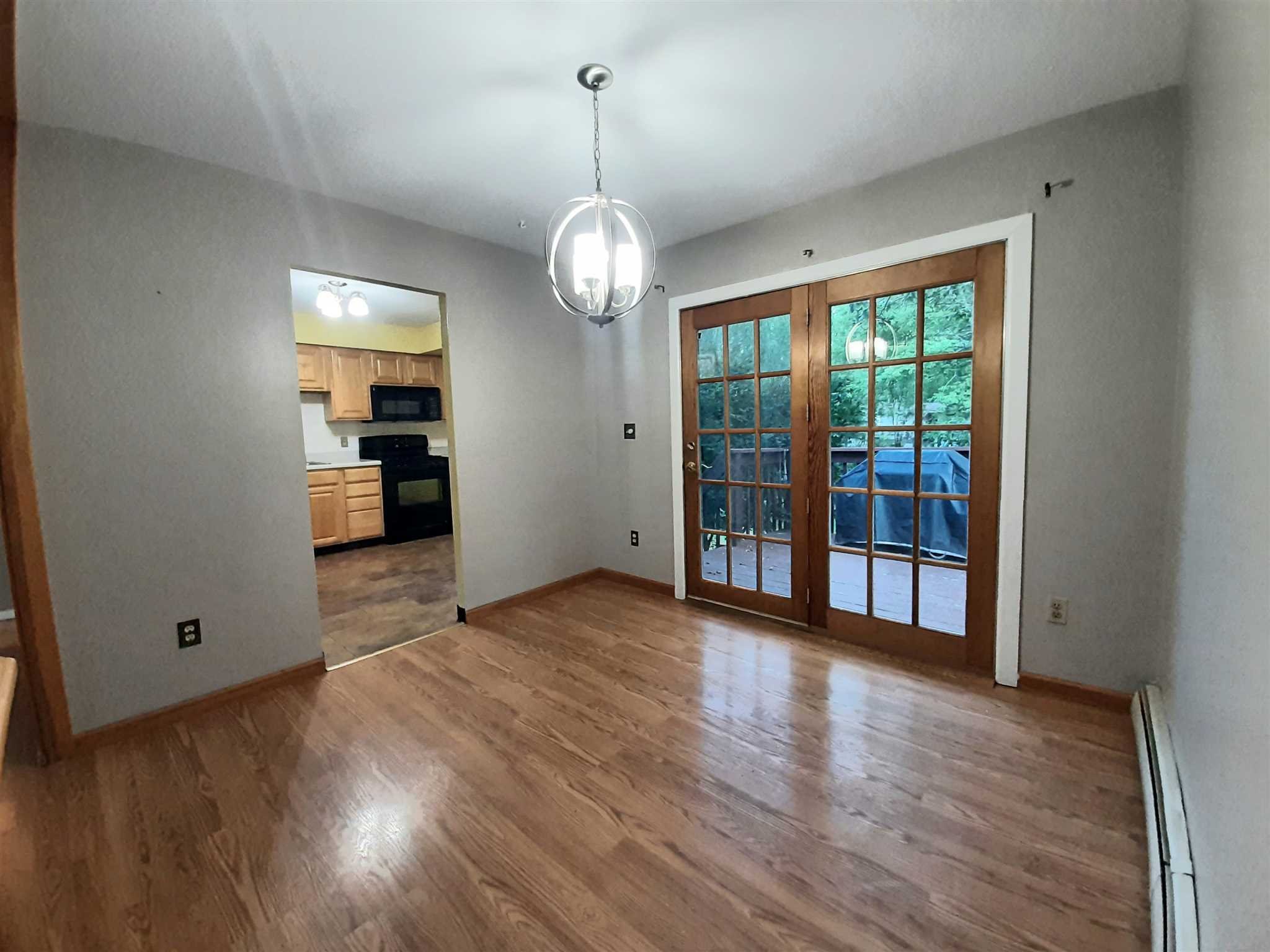 97 Sutton Park Road Poughkeepsie, NY 12603 - Photo 7 of 20 a view of a room with wooden floor staircase and windows