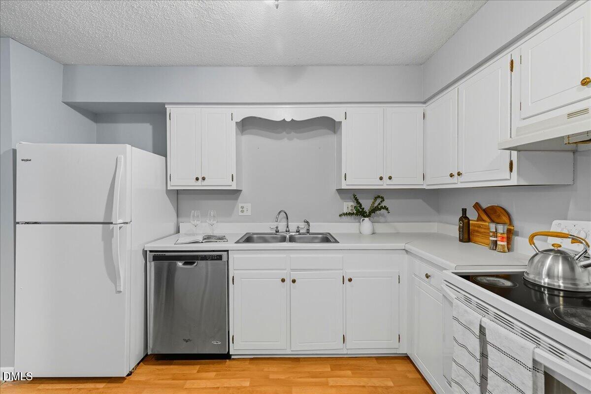 627 Pine Ridge Place Raleigh, NC 27609 - Photo 6 of 19 a kitchen with stainless steel appliances granite countertop a sink stove and refrigerator