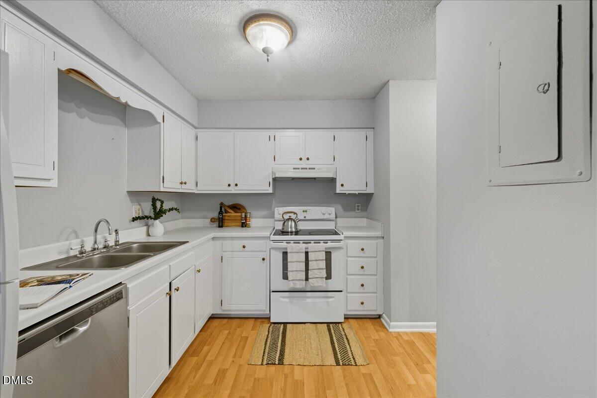 627 Pine Ridge Place Raleigh, NC 27609 - Photo 7 of 19 a kitchen with a sink cabinets and wooden floor