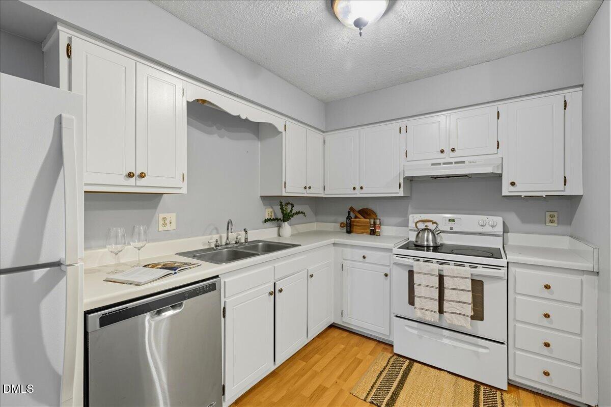 627 Pine Ridge Place Raleigh, NC 27609 - Photo 8 of 19 a kitchen with cabinets appliances a sink and a counter top