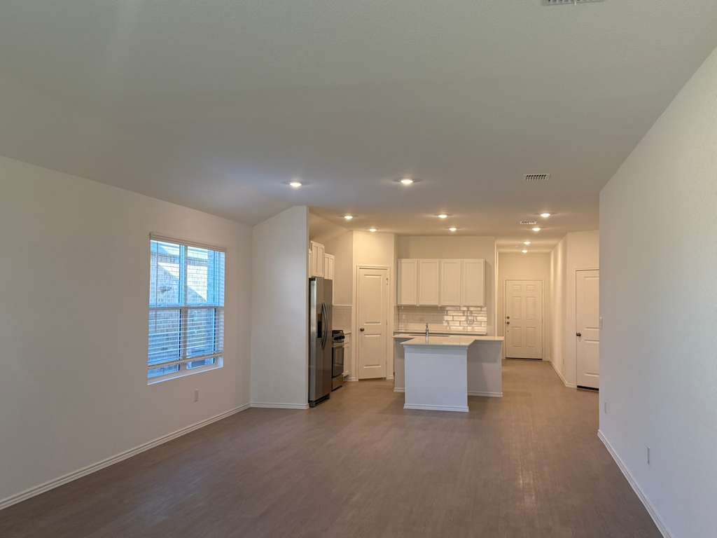 591 Sormonne Loop Kyle, TX 78640 - Photo 11 of 40 a view of a kitchen and refrigerator in a room
