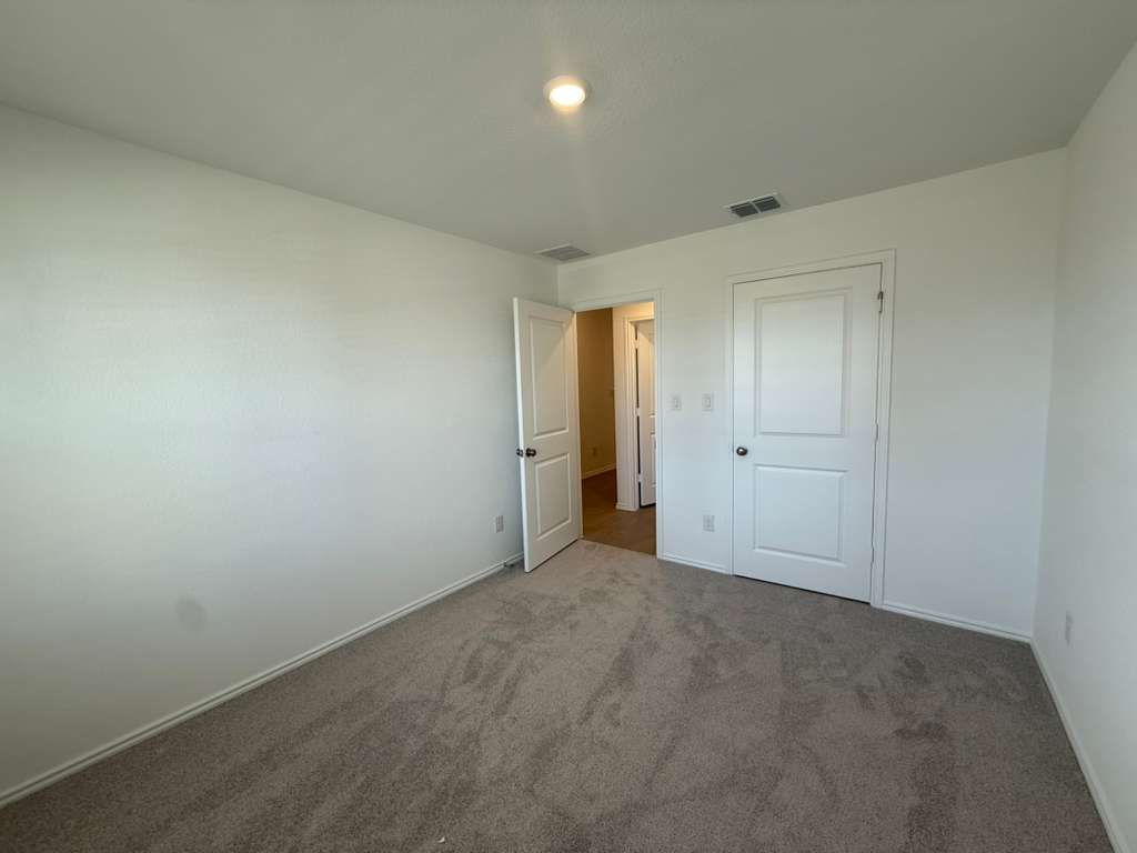 591 Sormonne Loop Kyle, TX 78640 - Photo 16 of 40 an empty room with an entryway