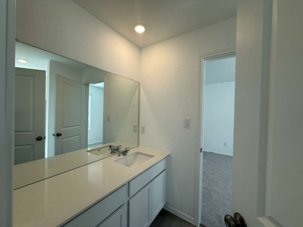 591 Sormonne Loop Kyle, TX 78640 - Photo 17 of 40 a bathroom with a sink and mirror