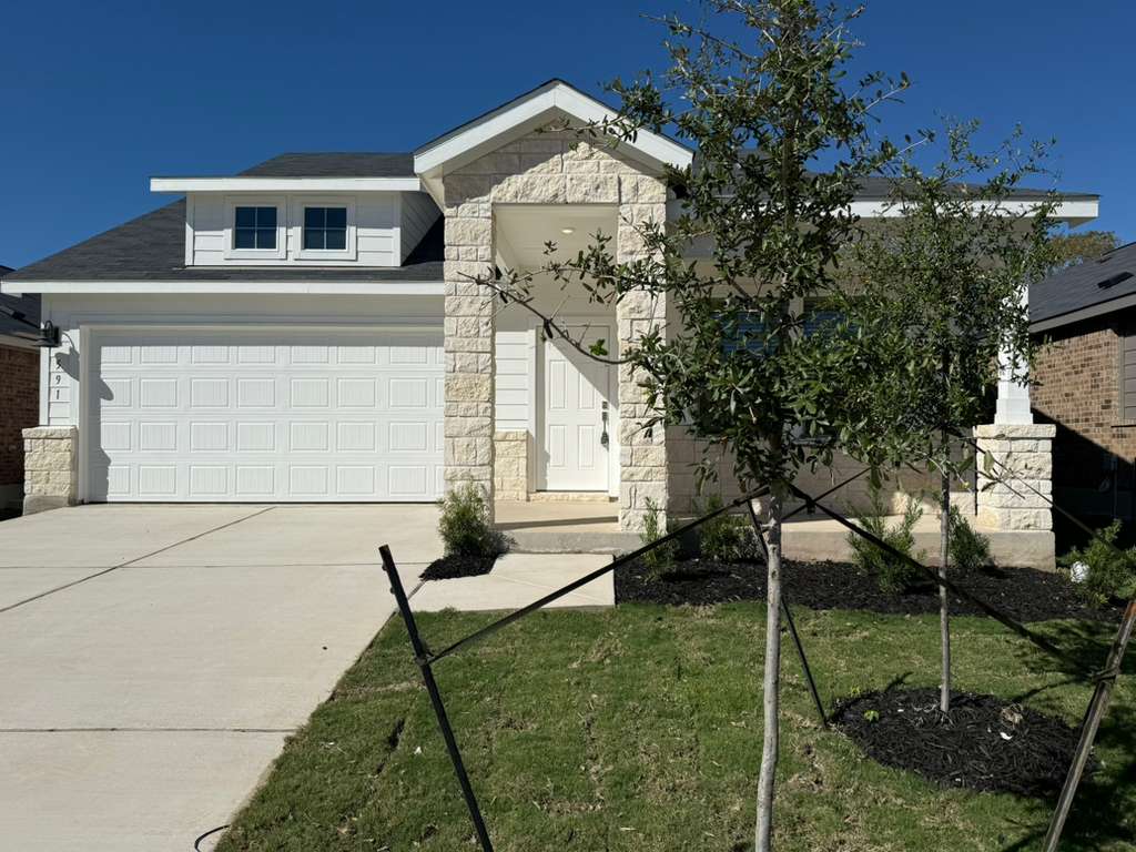 591 Sormonne Loop Kyle, TX 78640 - Photo 2 of 40 a front view of a house with garden