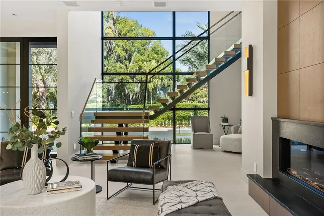 a living room with furniture and large windows