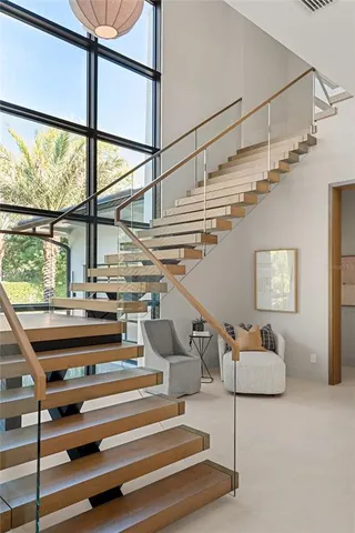 a bedroom with a bed and glass wall painting