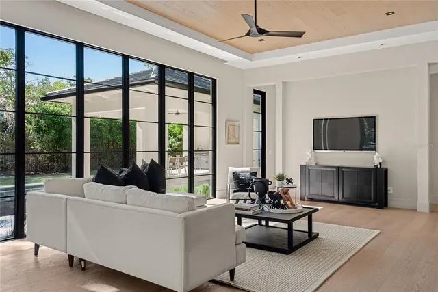 a view of a hallway with wooden floor and windows