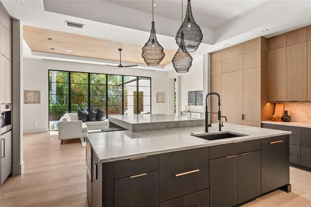 a view of a patio with table and chairs potted plants with wooden floor and fence