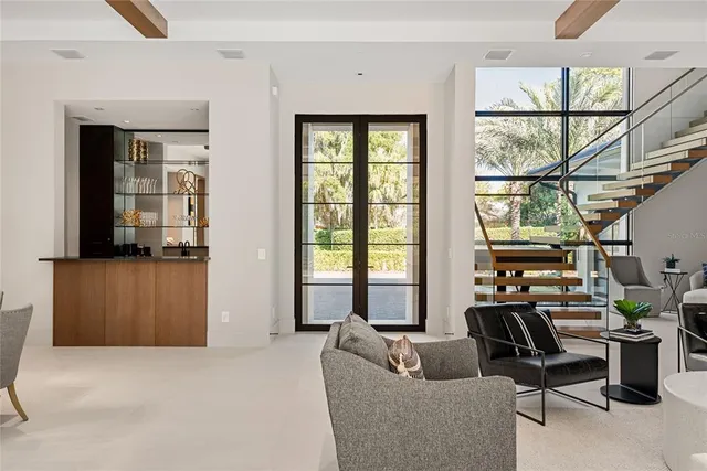a living room with couches and a large mirror with wooden floor