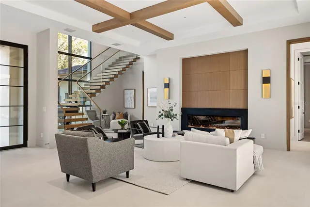 a living room with furniture flowerpot and wooden floor
