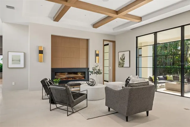 a dining room with furniture and a large window
