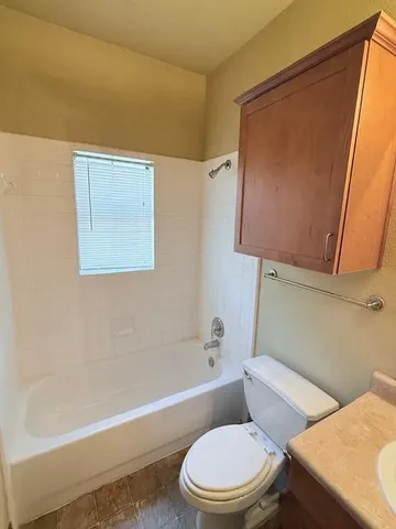 a bathroom with a toilet and a bathtub
